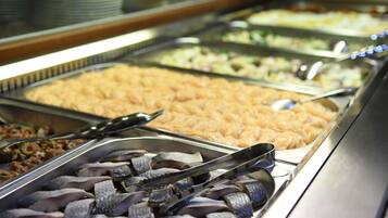 A buffet with various food items, including fish, salads, and other dishes.