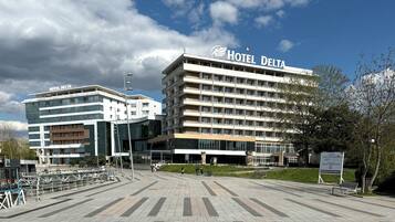 A hotel with a modern facade, multiple floors, and a prominent sign.