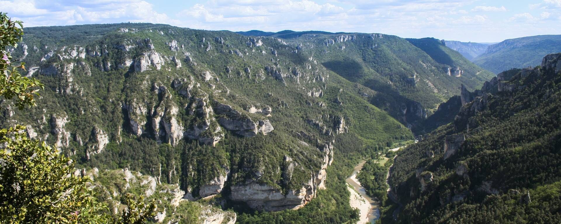 A mountainous landscape with a river running through a valley.