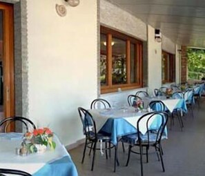 Enjoy meals under the sheltered roof, surrounded by large windows and comfortable seating.
