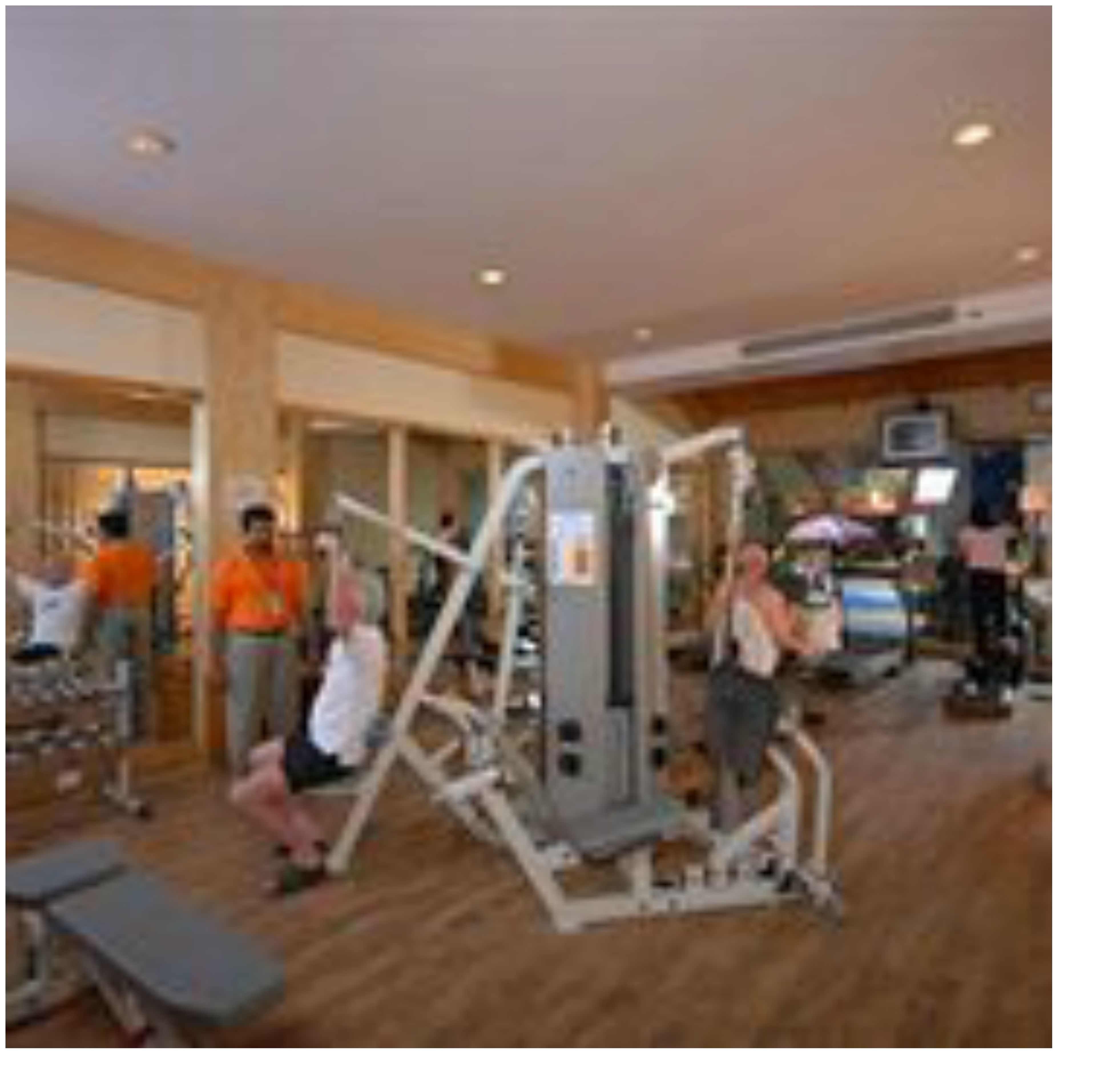 A gym with various exercise machines and equipment.