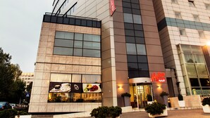 A modern hotel with a prominent 'Hello!' sign, large windows, and a clean facade. - Hello Hotels Bucharest (Bucharest)