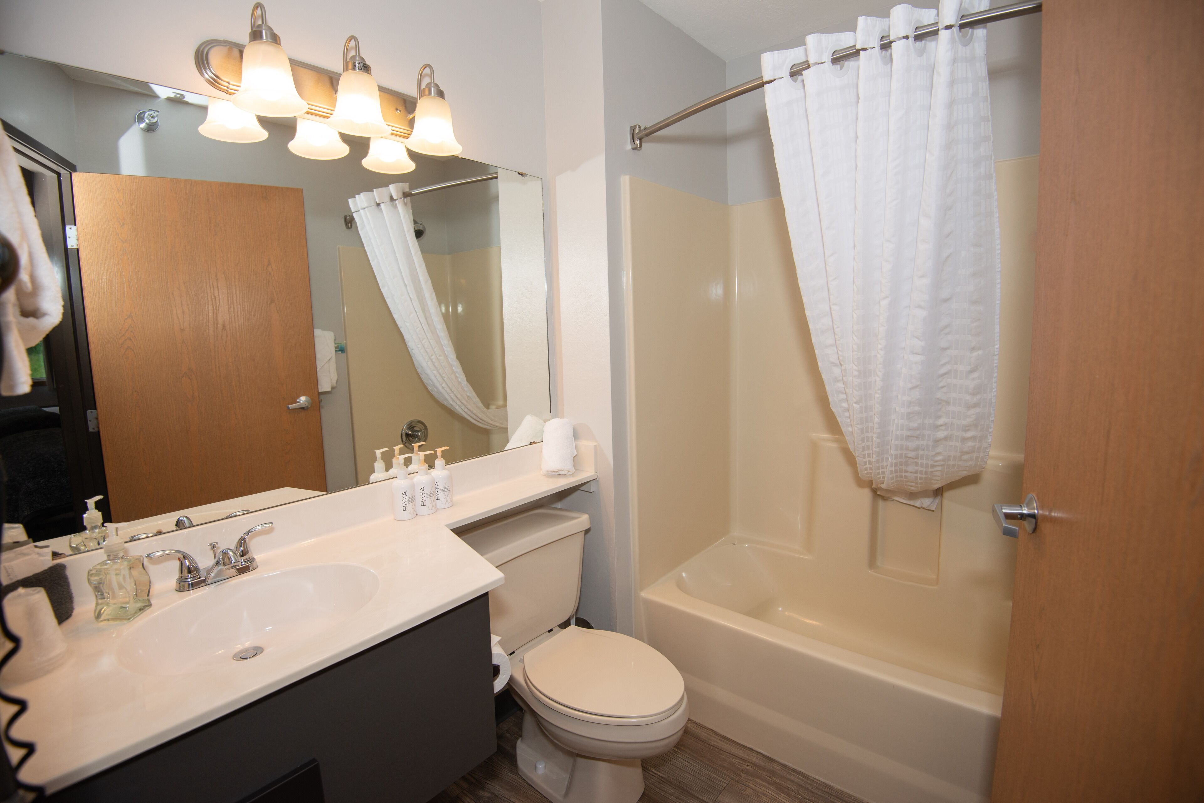 A bathroom with a sink, toilet, and bathtub.