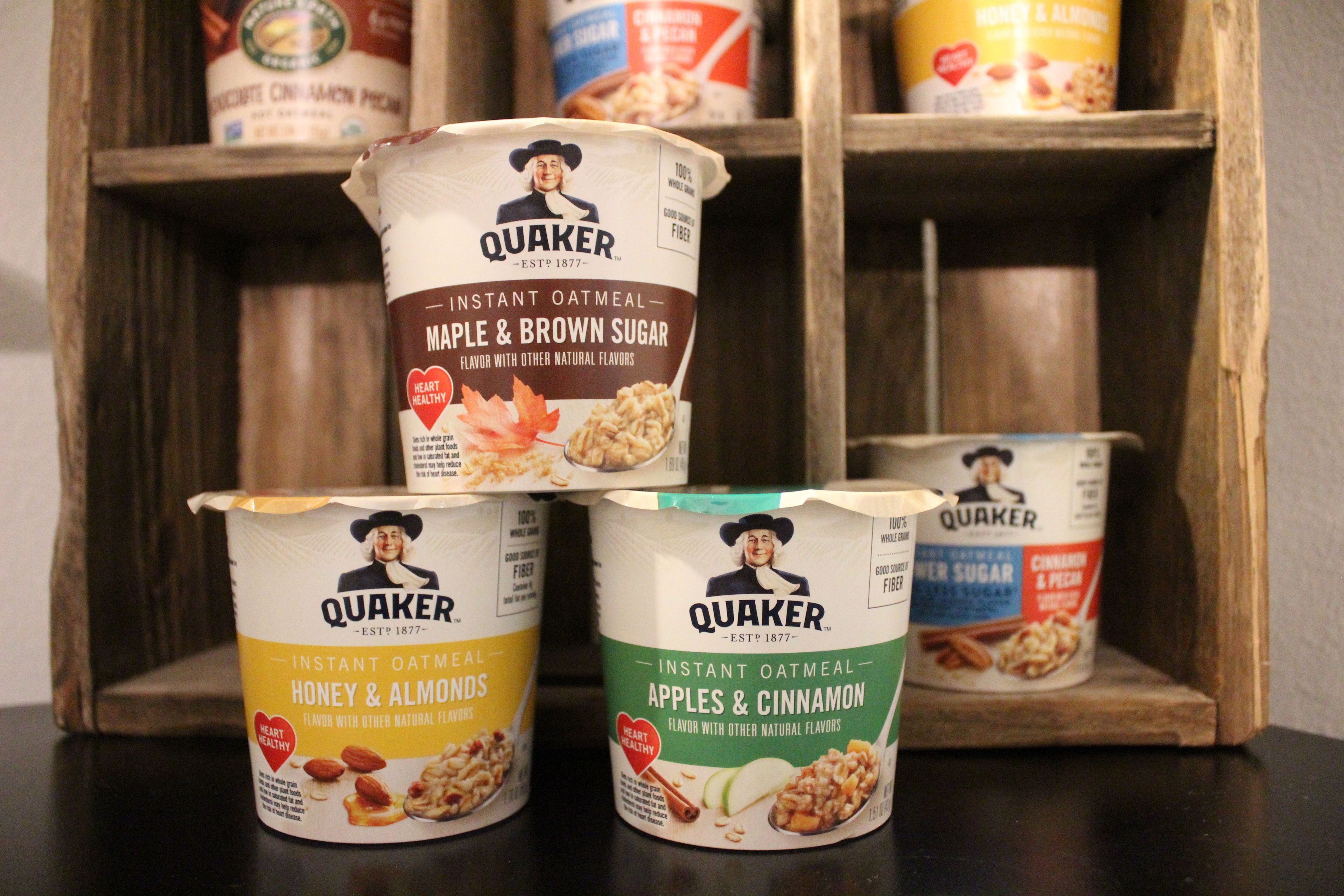 Quaker instant oatmeal containers on a shelf.