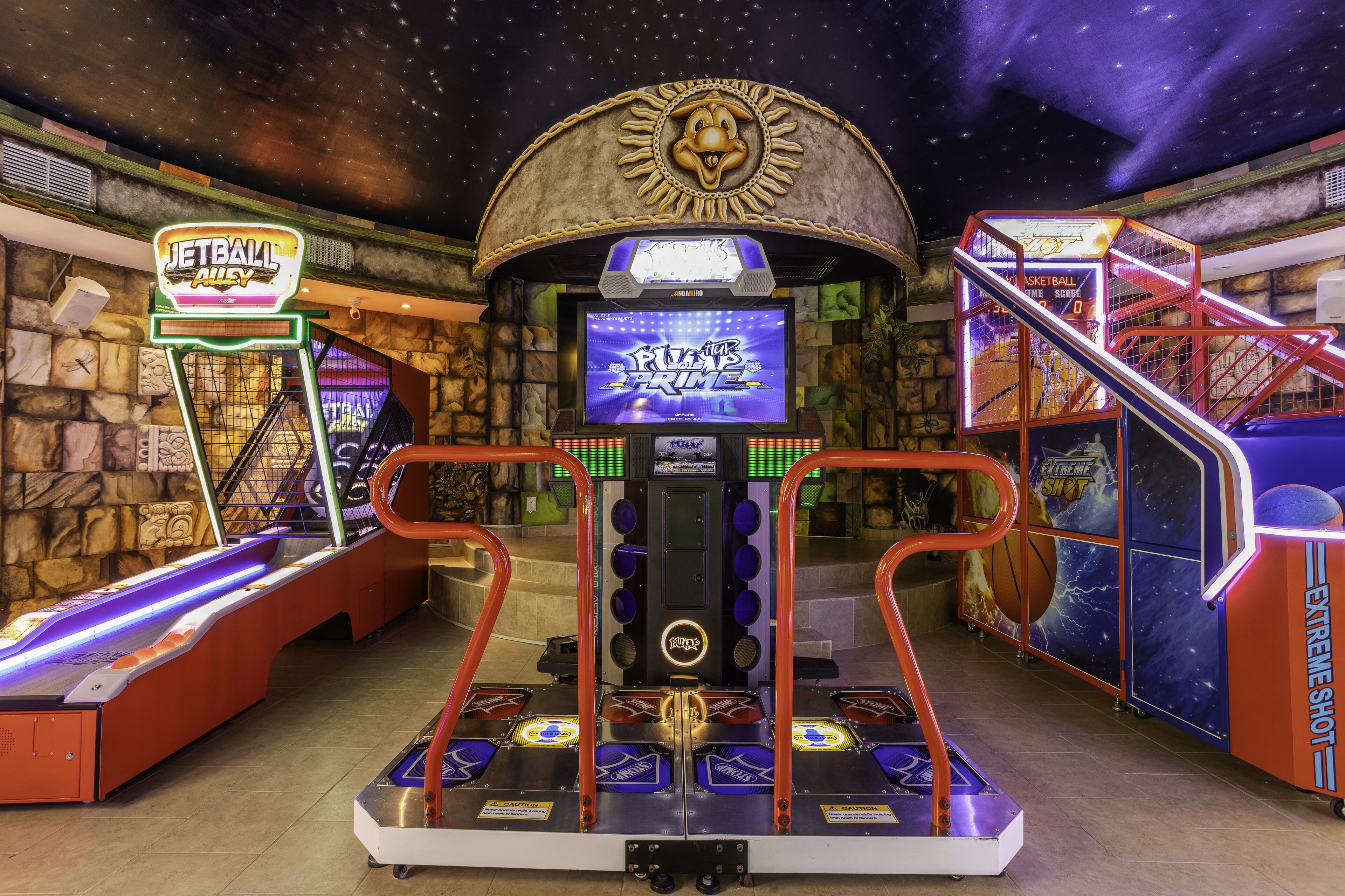 An indoor arcade with various gaming machines, including a basketball game and a claw machine.