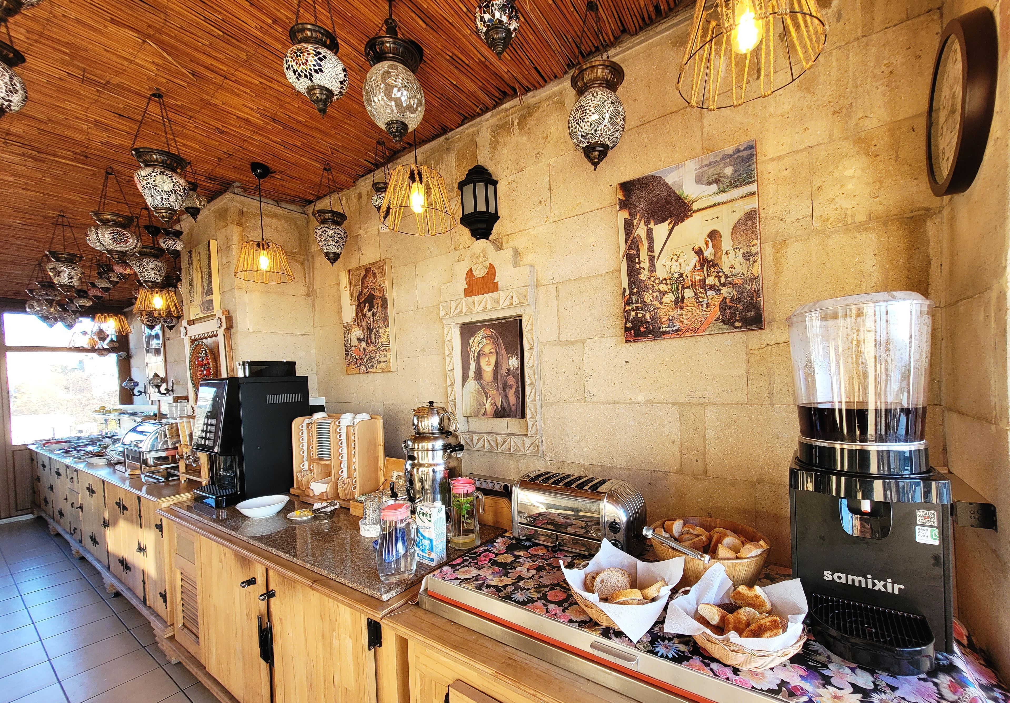 A kitchen with a coffee machine, toaster, and various food items on the counter.