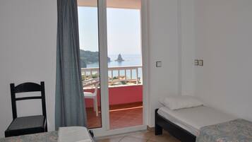 Economy Triple Room, Partial Sea View | Hypo-allergenic bedding, in-room safe, desk