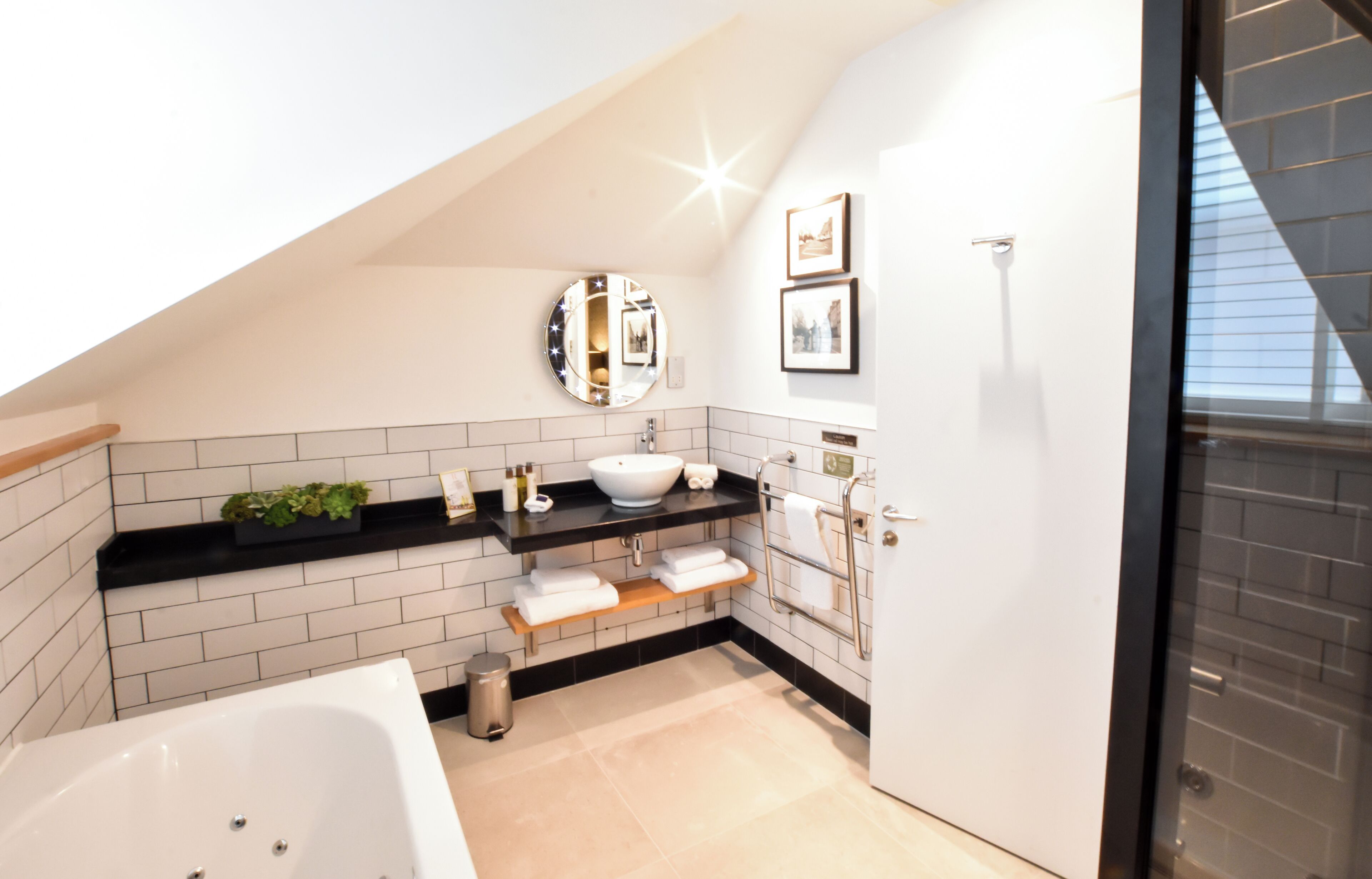 junior suite | bathroom | combined shower/bathtub, designer toiletries, hair dryer, bathrobes