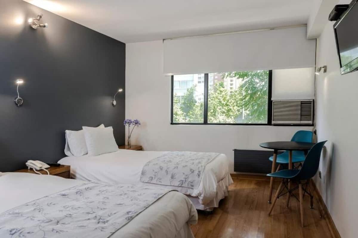 Twin Room | Minibar, in-room safe, individually decorated, individually furnished