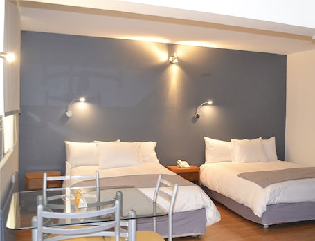 Triple Room | Minibar, in-room safe, individually decorated, individually furnished