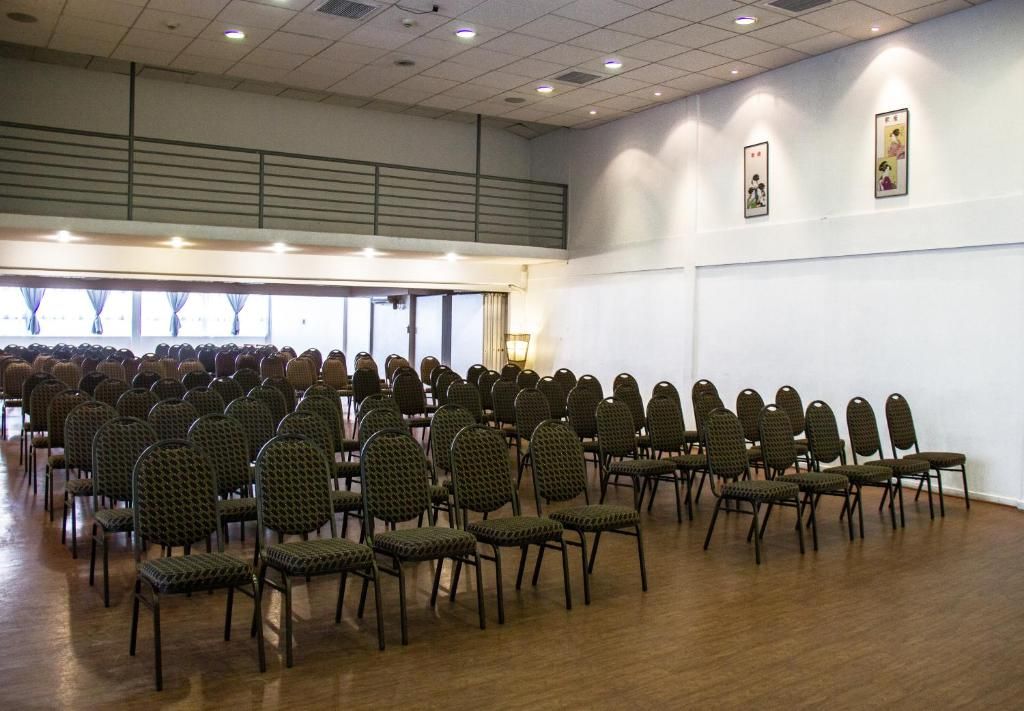 A conference room with rows of chairs and a large window.