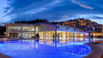Experience the hotel's unique architecture and unwind by the illuminated pool.