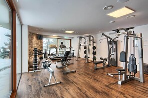 A gym with treadmills, weight machines, and free weights. - Wellness & Spa Hotel Kaskady (Sliac)