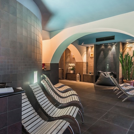 A spa area with a reception desk, seating, and a Buddha statue.