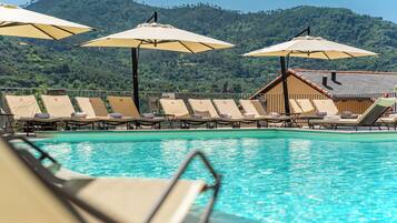 Relax by the pool surrounded by lush green hills and enjoy ample space to unwind.