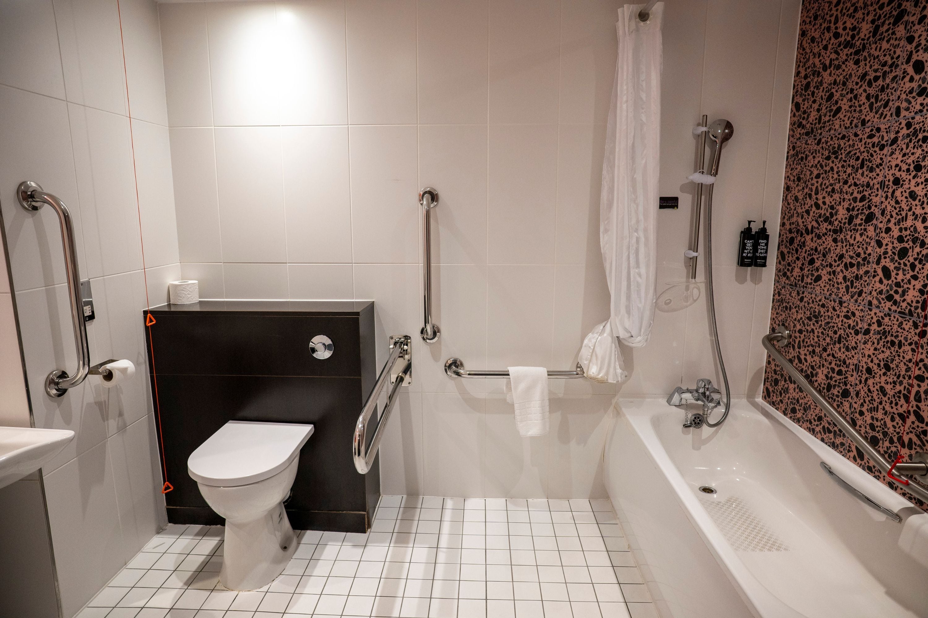 A bathroom with a white toilet, a sink, a bathtub, and a shower.