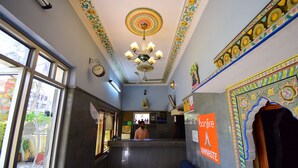 A reception area with a counter, a clock, and a sign for 'Bonfire Namaste'.