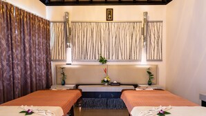 A spa room with two beds, a wooden ceiling, and a wall-mounted artwork. - Avani Ao Nang Cliff Krabi Resort (Krabi)