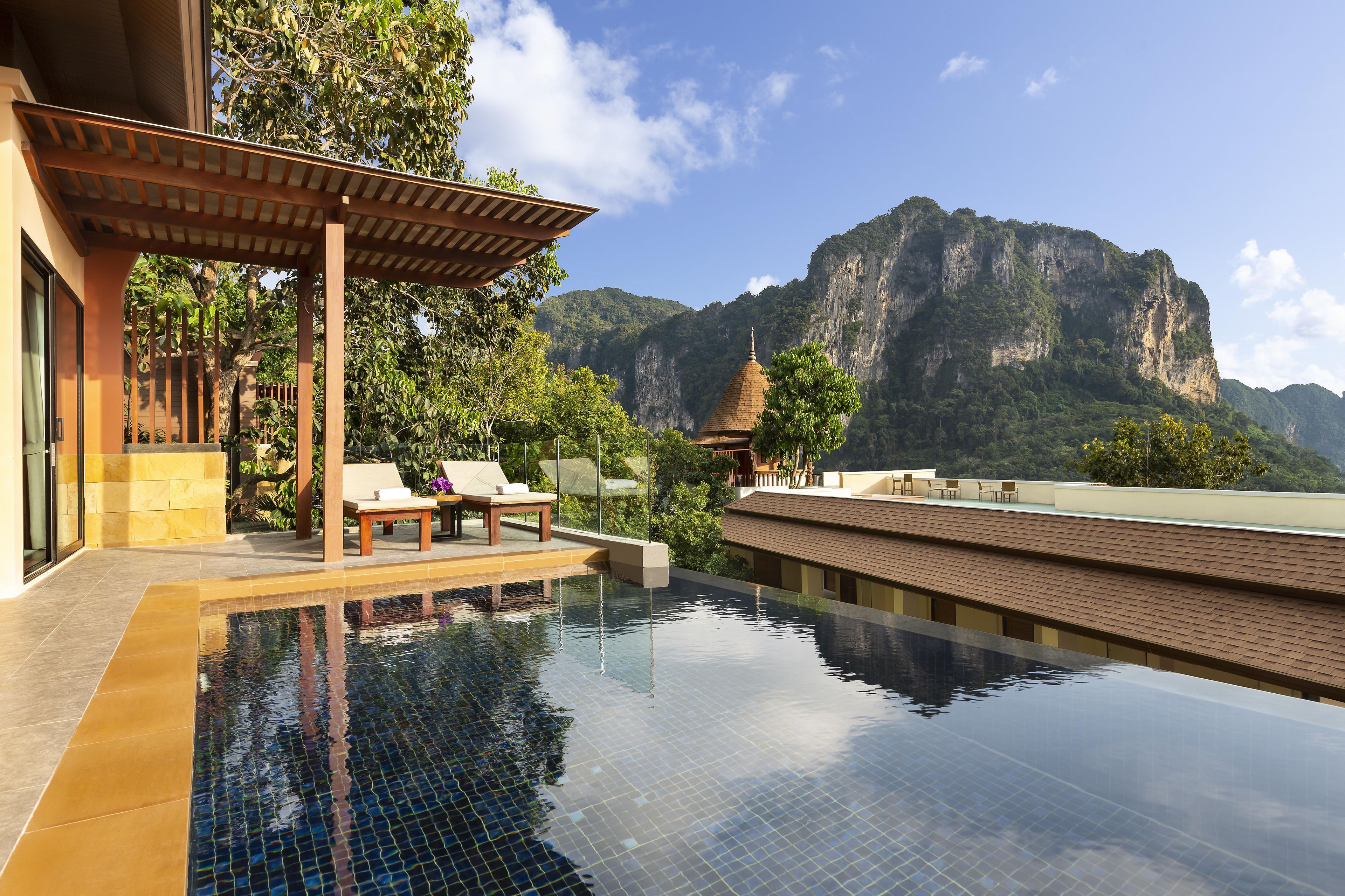 A infinity pool with a view of a mountain.