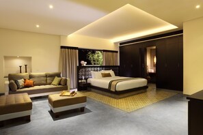A modern hotel room with a sofa, a bed, a nightstand, and a desk. - Xandari Harbour Fort Kochi (Kochi)