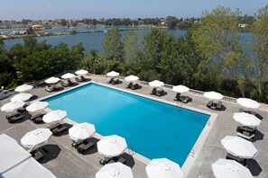 Seasonal outdoor pool, open 9:00 AM to 8:00 PM, pool umbrellas