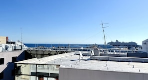 A rooftop with satellite dishes, antennas, and a view of the sea and a cruise ship. - Savoy City Hotel (Rhodes)