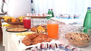 A breakfast buffet with various food items and beverages. - San Gabriele (Loreto)