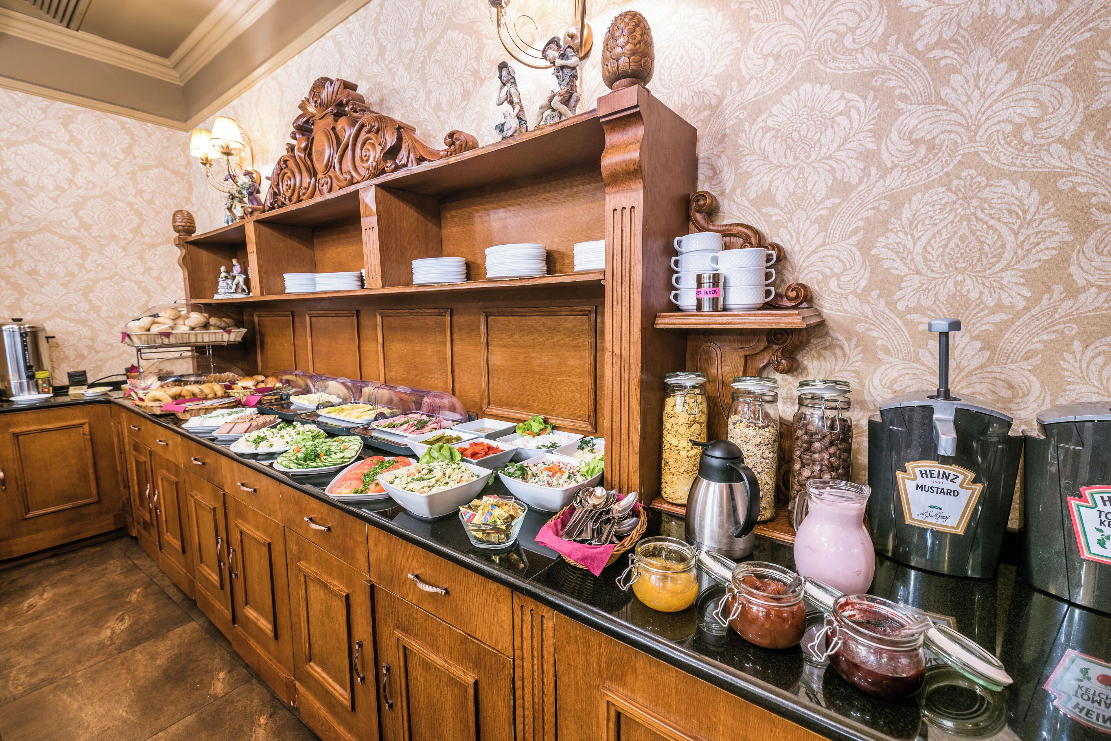 A buffet with various food items and condiments.