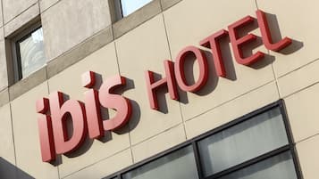 A hotel sign with the name 'ibis HOTEL' in large, bold letters.