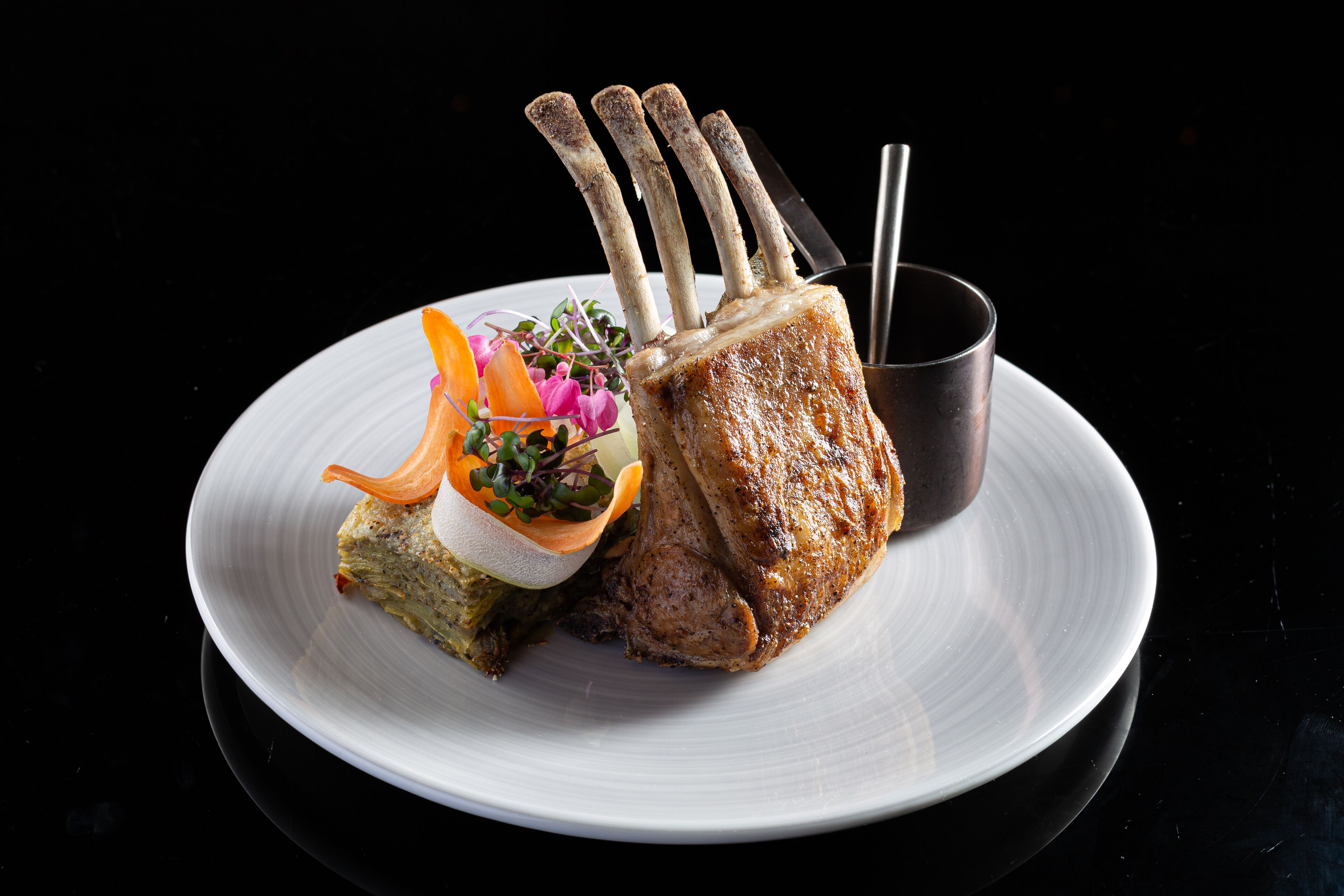 A plate with a roasted meat dish and a side salad.
