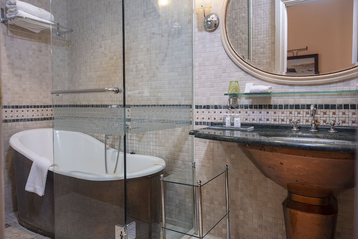 deluxe room | bathroom | designer toiletries, hair dryer, bathrobes, slippers