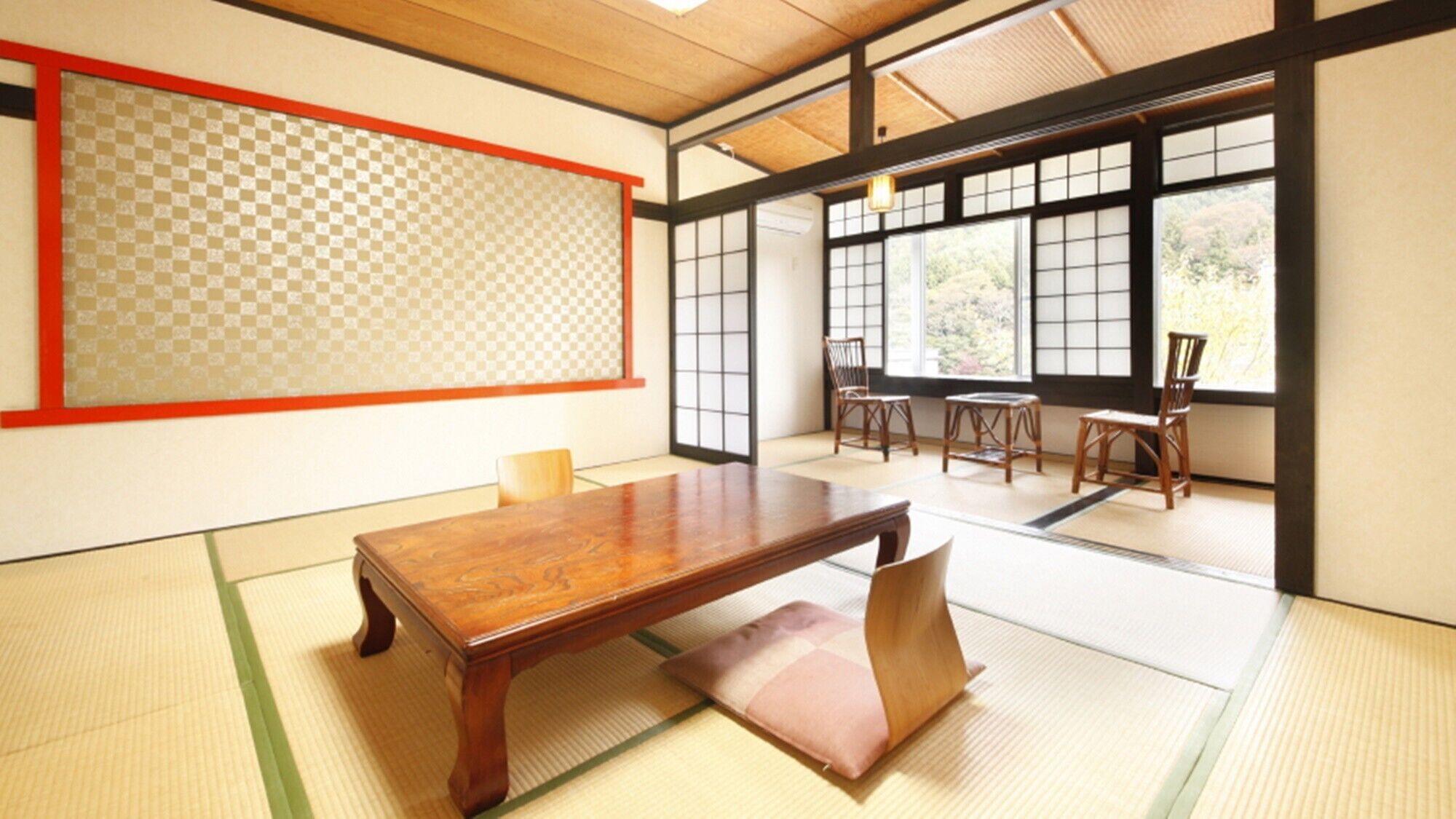 A traditional Japanese room with tatami flooring, a low wooden table, and sliding doors.