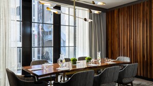 A conference room with a long wooden table, six chairs, and a modern chandelier. - Kimpton Hotel Palomar Philadelphia by IHG (Philadelphia)