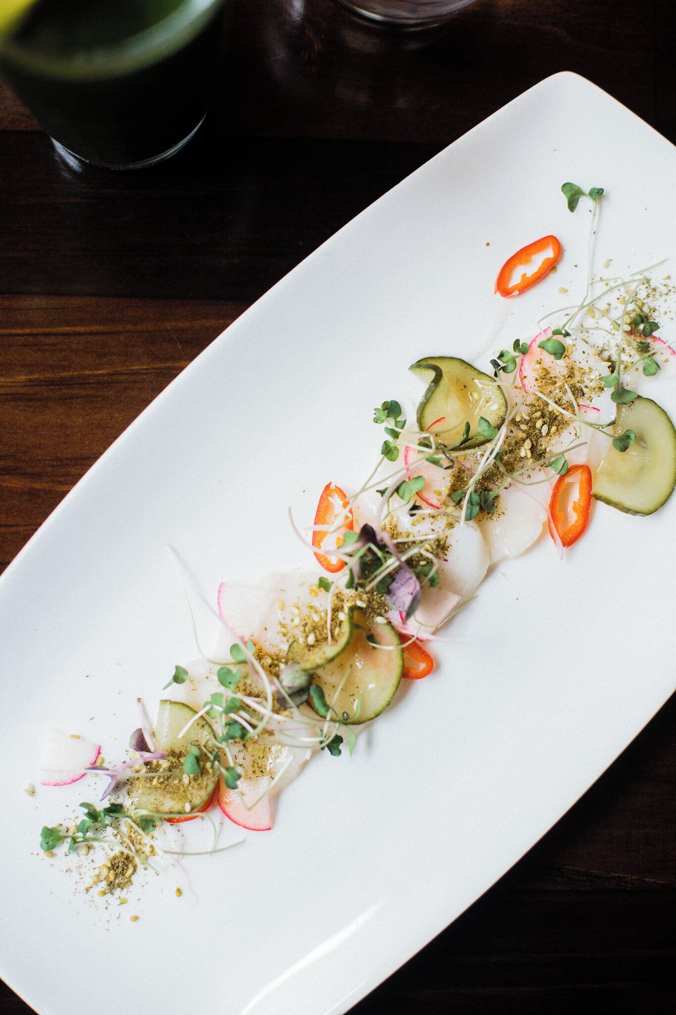 A white rectangular plate with a food arrangement.