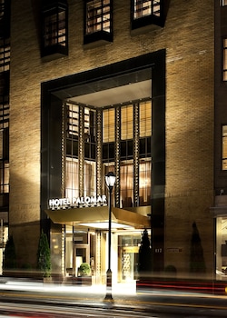 A conference room with a long wooden table, six chairs, and a modern chandelier. at Kimpton Hotel Palomar Philadelphia by IHG
