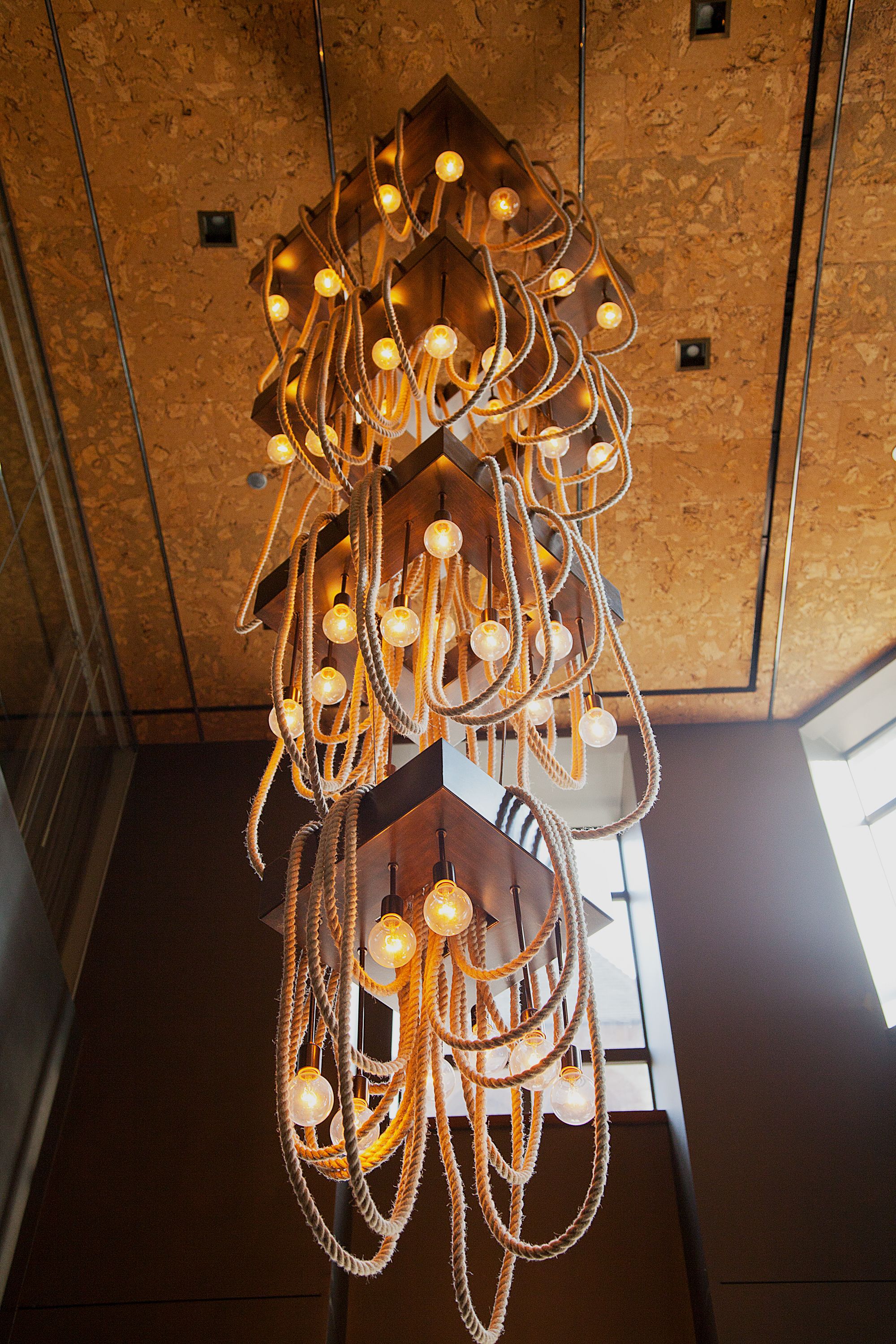 A chandelier with multiple light bulbs and twisted metal elements.