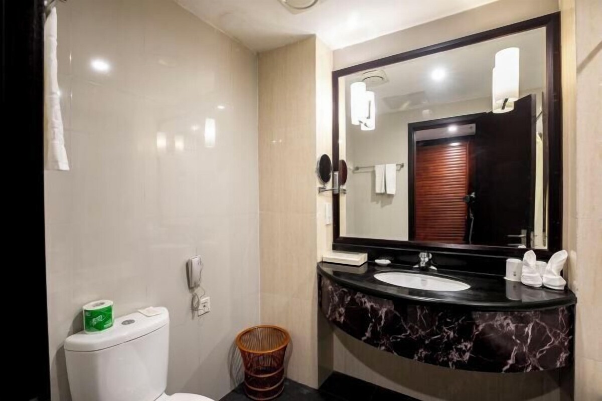 Een moderne badkamer met toilet, douchetoilet en wastafel.