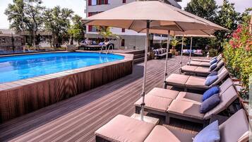 Seasonal outdoor pool, pool umbrellas, pool loungers