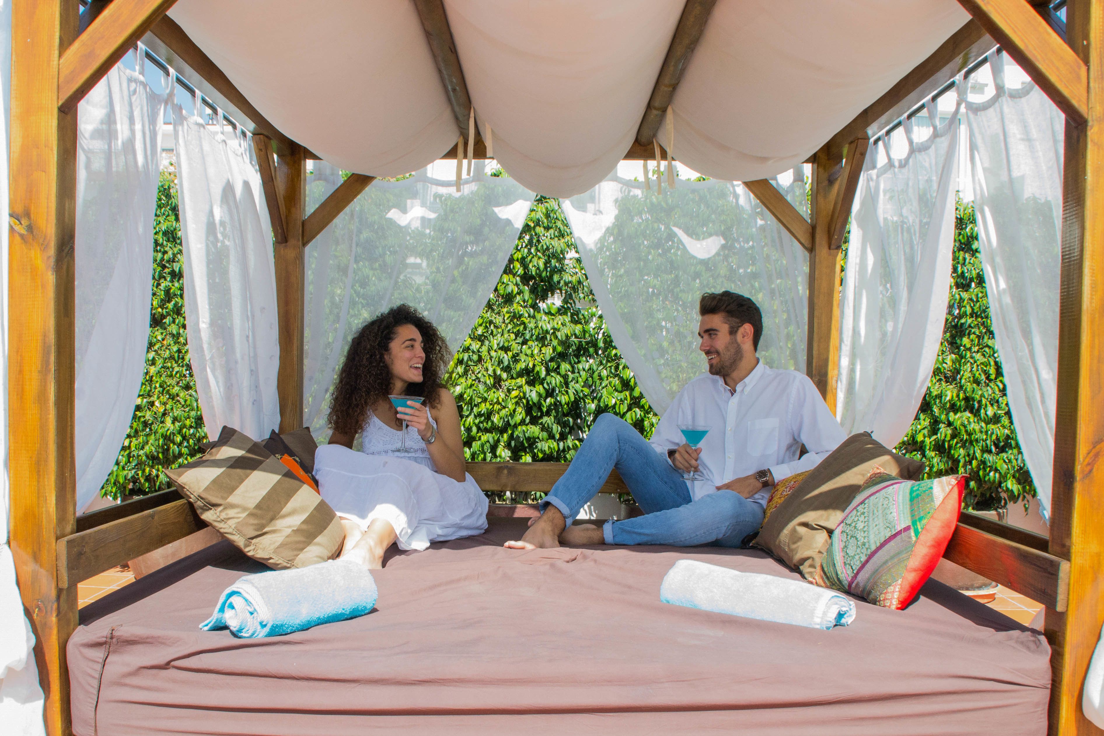 A cozy room with a bed, pillows, and a canopy.