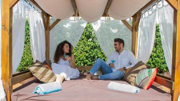 A cozy room with a bed, pillows, and a canopy.