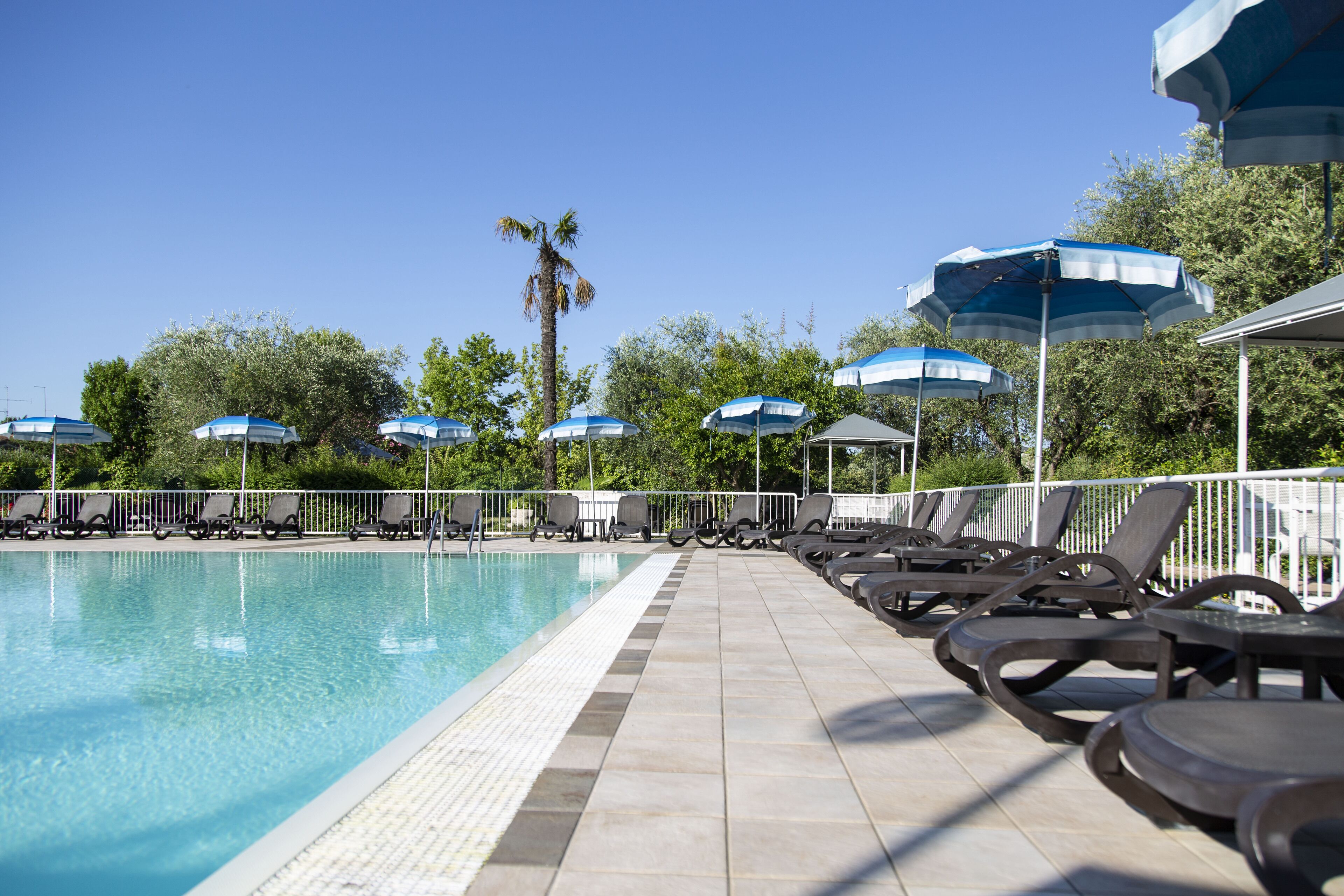 seasonal outdoor pool, pool umbrellas, pool loungers
