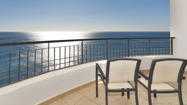 A balcony with two chairs facing a sea view. - Olée Nerja Holiday Rentals By Fuerte Group (Torrox)