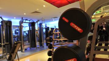A gym with exercise equipment, including dumbbells and a treadmill.