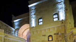 A stone building with a staircase leading to an upper level. - Perimasali Cave Hotel - Cappadocia (Ürgüp)