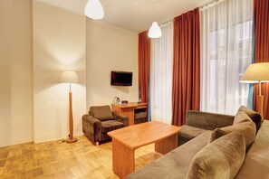 Relax in this stylish living room with a sofa, armchair, and flat-screen TV.