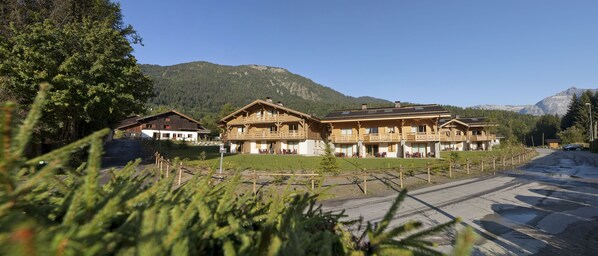 A chalet-style hotel with multiple balconies and a mountain backdrop. - CGH Le Hameau de Pierre Blanche (Les Houches)
