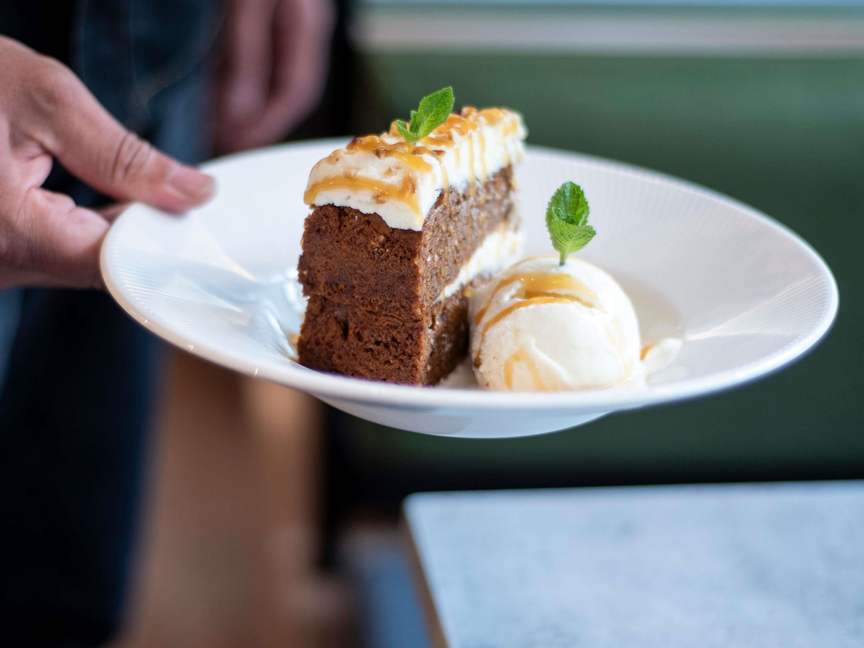 A dessert plate with a slice of cake and a scoop of ice cream.