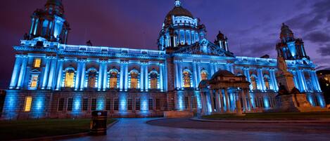 A grand building with classical architecture, featuring a large dome and two prominent towers.