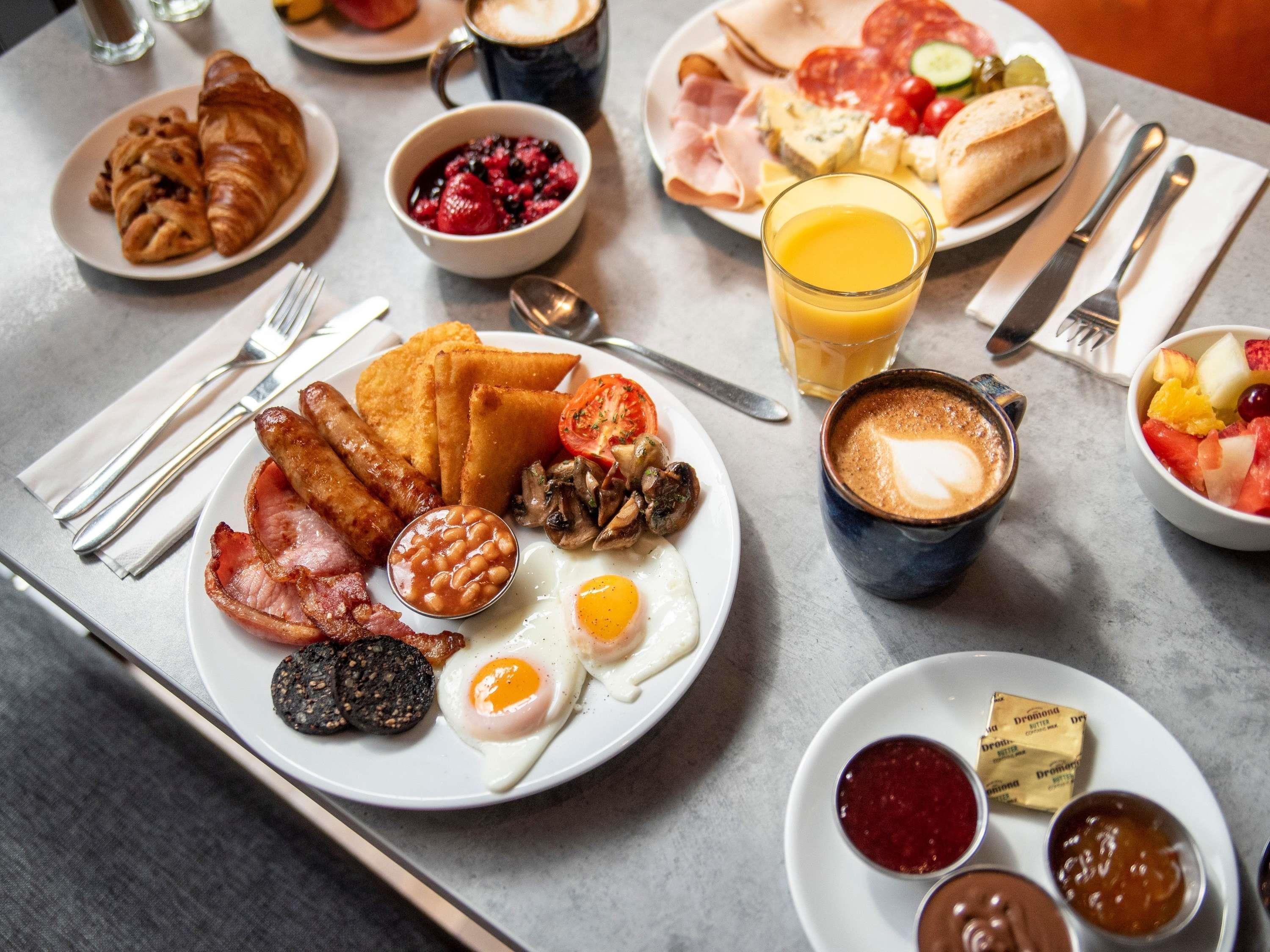 A breakfast spread with eggs, sausages, and toast.