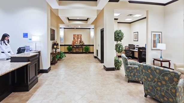 A hotel lobby with a reception desk, seating area, and a reception counter. - Holiday Inn Express Hotel & Suites Brownfield by IHG (Brownfield)